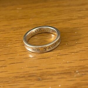 Tiffany & Co. Silver Narrow Engraved Logo Band Size 6.5